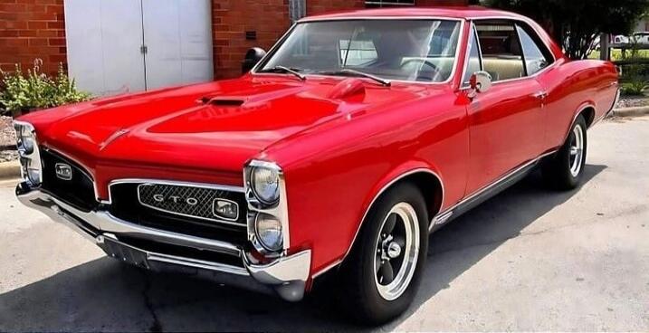 GTO badge on vintage red Pontiac car