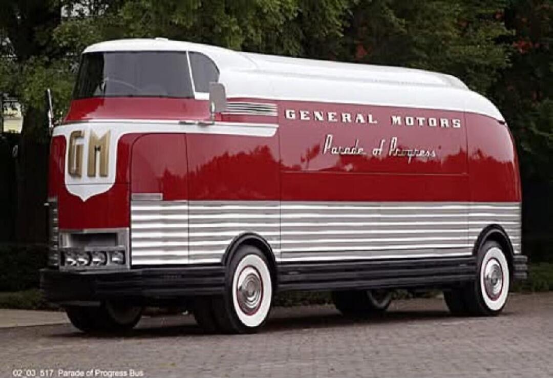 GM General Motors Parade of Progress. A vintage red and white bus with the text 'GM', 'GENERAL MOTORS', and 'Parade of Progress' visible on its side. There is also small text '02 03 517 Parade of Progress Bus' at the bottom left.
