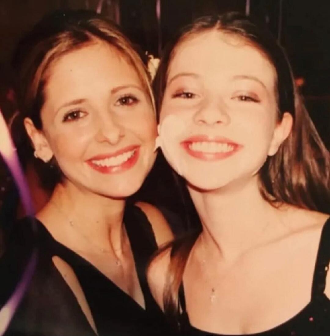 Two young women smiling.