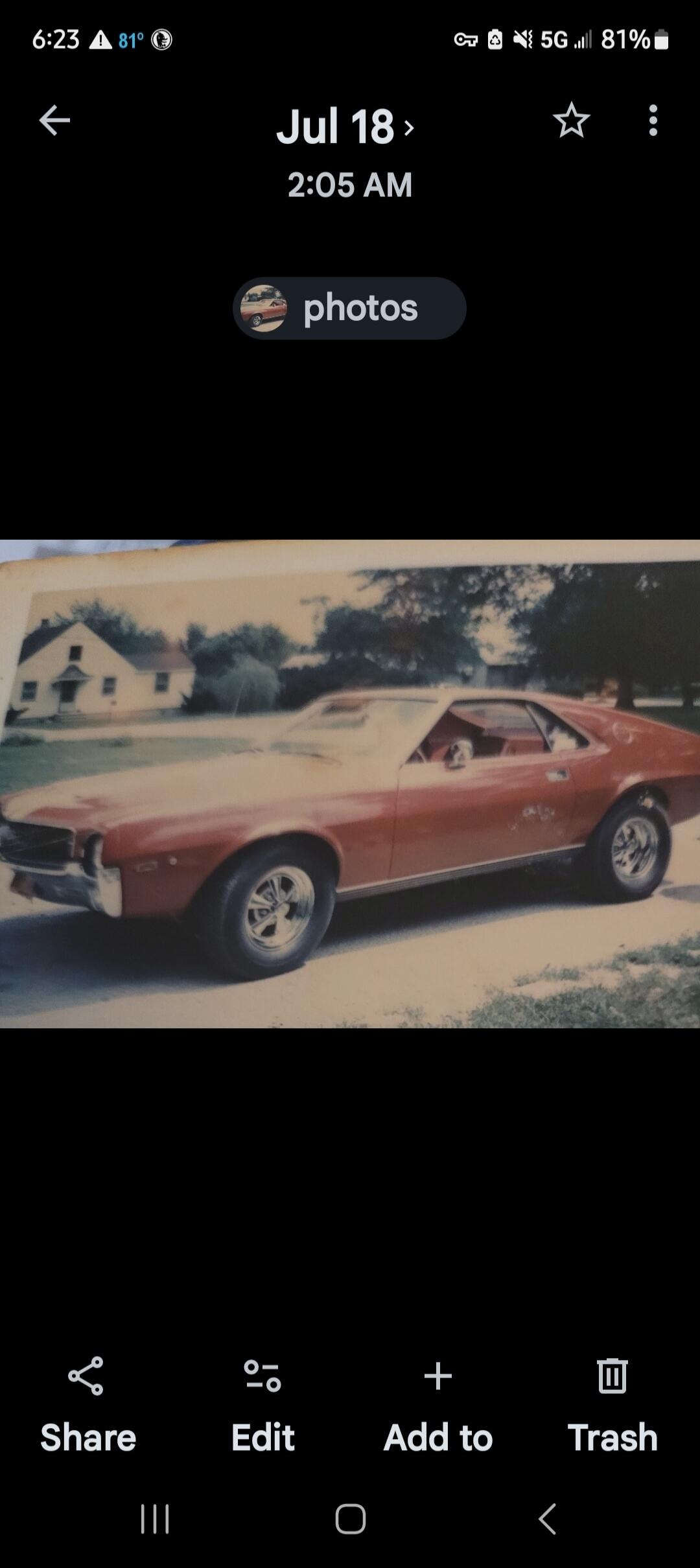 6:23 81° Jul 18 2:05 AM photos Share Edit Add to Trash. A vintage red car is parked in front of a house.