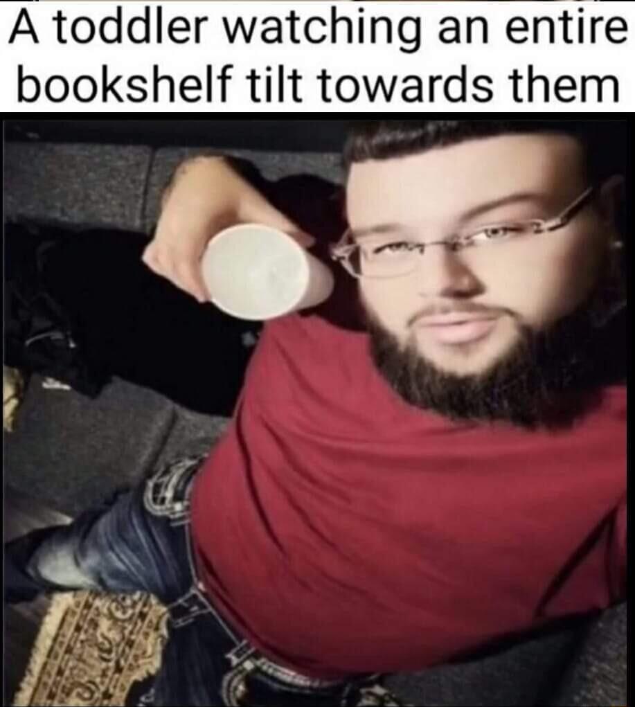 A toddler watchlng an entire bookshelf tilt towards them