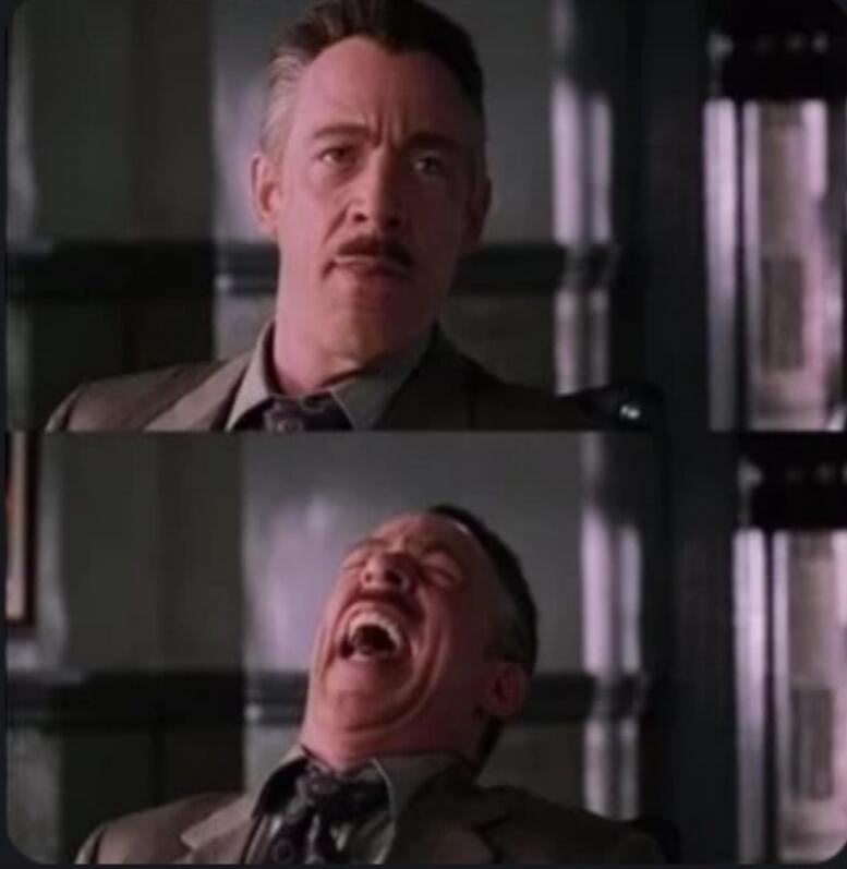 A man with a mustache looks serious, then laughs hysterically.