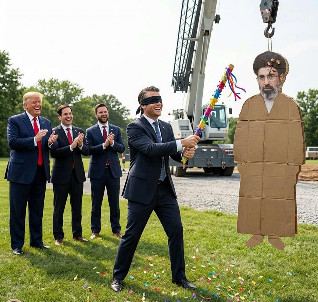 A group of men in suits, including Donald Trump, are laughing and clapping as a blindfolded man prepares to hit a piñata shaped like Ayatollah Ali Khamenei with a stick. Confetti is scattered on the grass, and a crane holds the piñata.