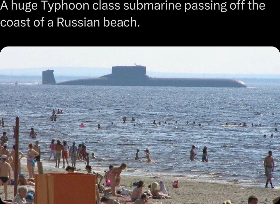 uge Typhoon class submarine passing off the coast of a Russian beach