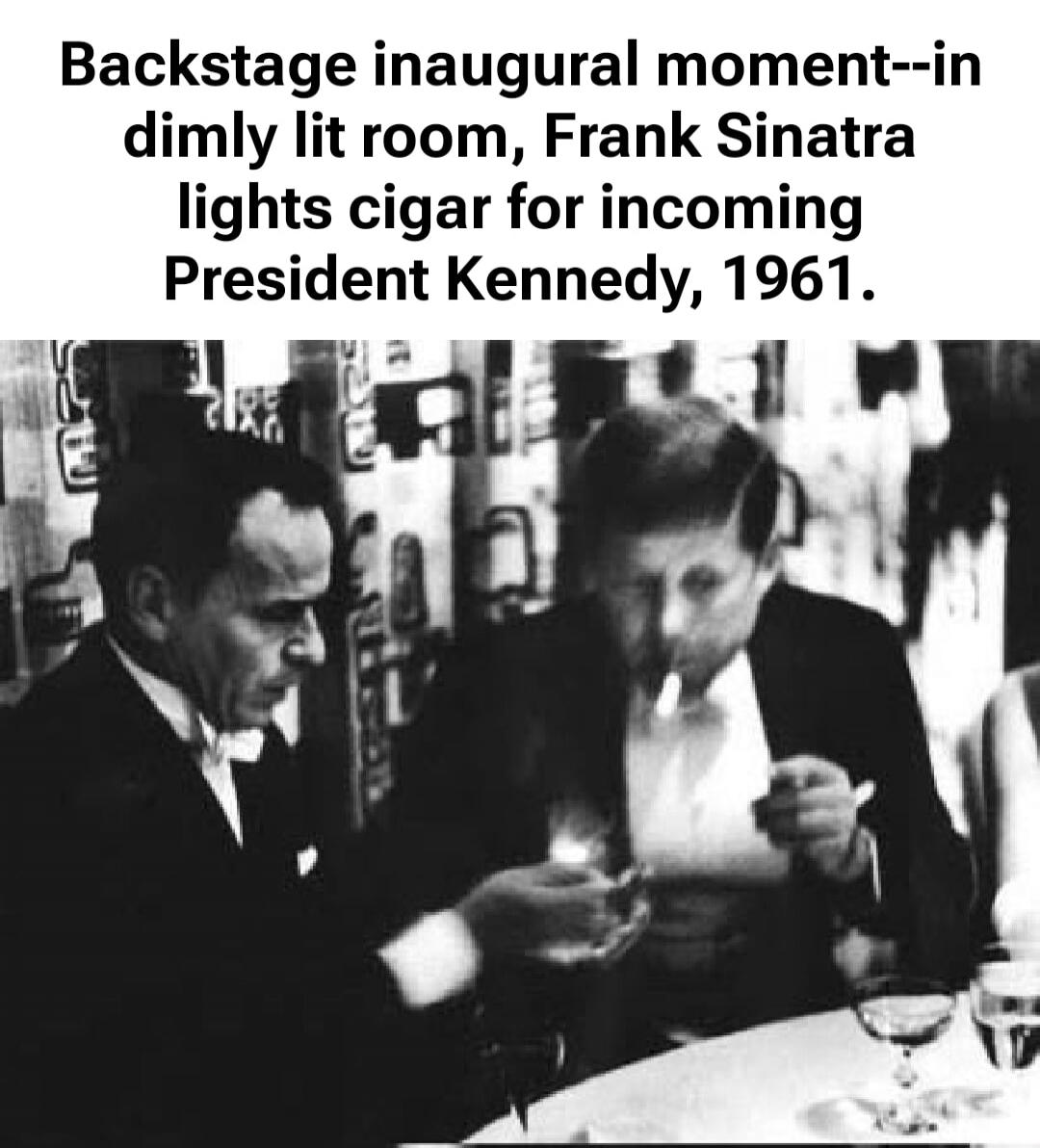 Backstage inaugural moment--in dimly lit room, Frank Sinatra lights cigar for incoming President Kennedy, 1961.