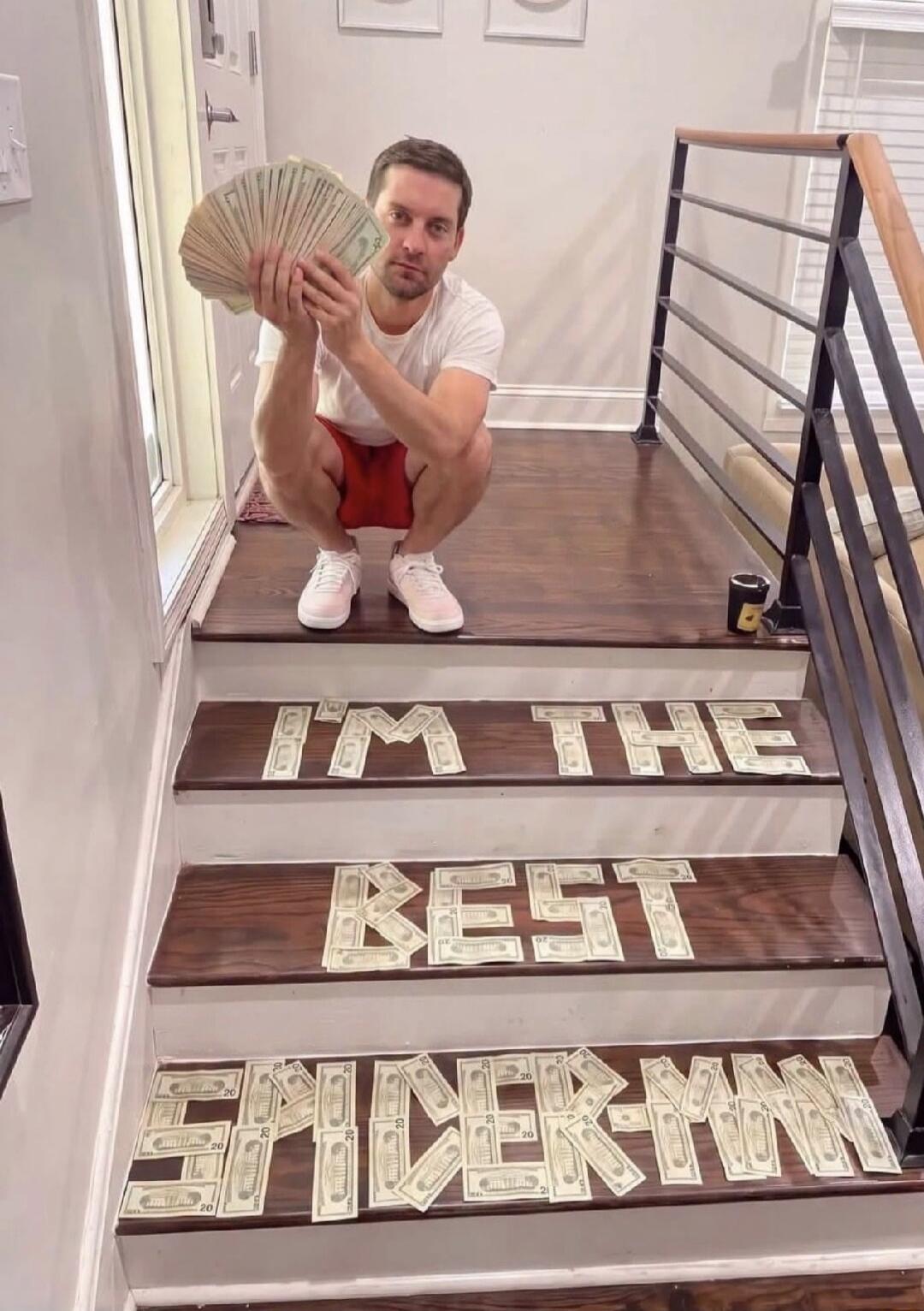 I'M THE BEST SPIDER-MAN. Tobey Maguire is seen holding a large fan of money.