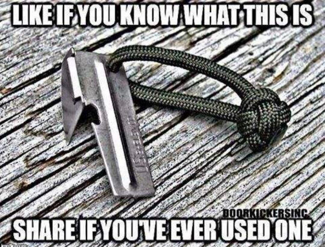 LIKE IF YOU KNOW WHAT THIS IS SHARE IF YOU'VE EVER USED ONE DOORKICKERSINC. The image shows a P-38 can opener with a paracord loop, resting on a wooden surface.