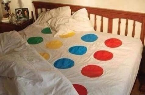 Twister game mat spread on a bed
