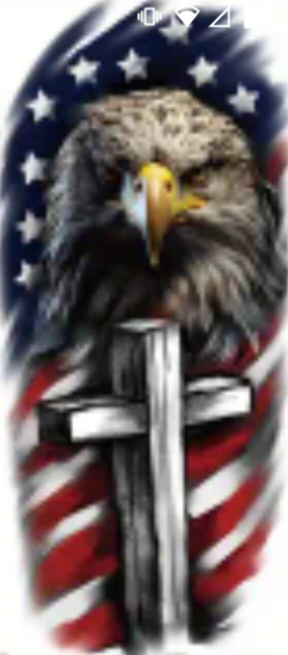 An eagle perched behind a large cross with an American flag motif in the background.
