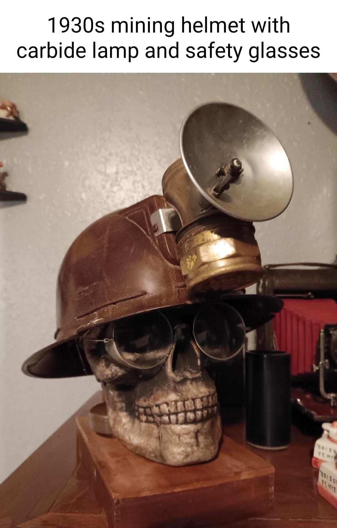 1930s mining helmet with carbide lamp and safety glasses