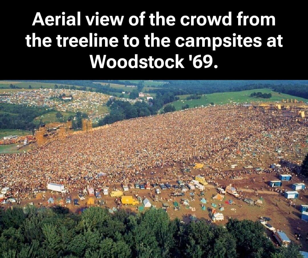 Aerial view of the crowd from the treeline to the campsites at Woodstock '69.