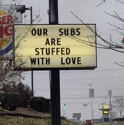 OUR SUBS ARE STUFFED WITH LOVE. (Sign for a sandwich shop)