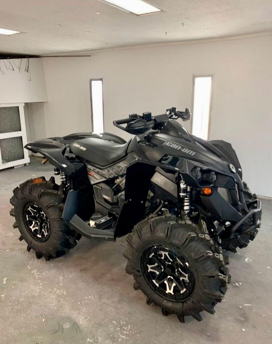 Can-Am ATV with large off-road tires in a garage