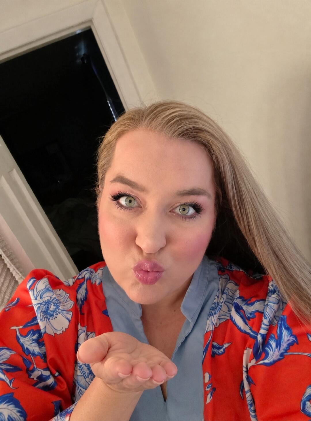 A woman blowing a kiss.