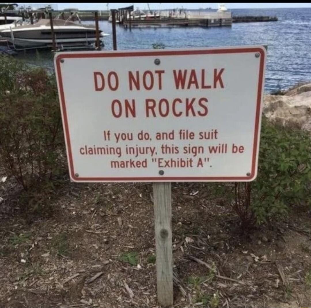 DO NOT WALK ON ROCKS f you do and file suit claiming injury this sign will be marked Exhibit A