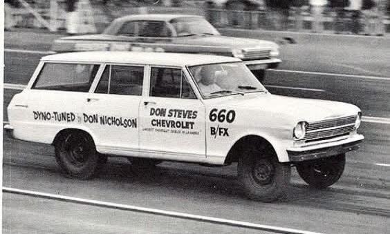 DYNO-TUNED DON NICHOLSON DON STEVES CHEVROLET 660 B/FX. A vintage white Chevrolet Nova station wagon, modified for drag racing, is speeding down a race track. Another car is visible in the background.