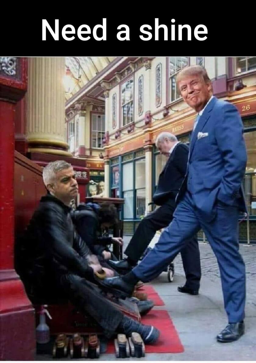 Need a shine. Donald Trump, wearing a blue suit, is smiling while having his shoes shined by a person sitting on the ground. Jose Mourinho is also visible, sitting and looking away, seemingly waiting or also getting his shoes shined in a busy outdoor market setting.