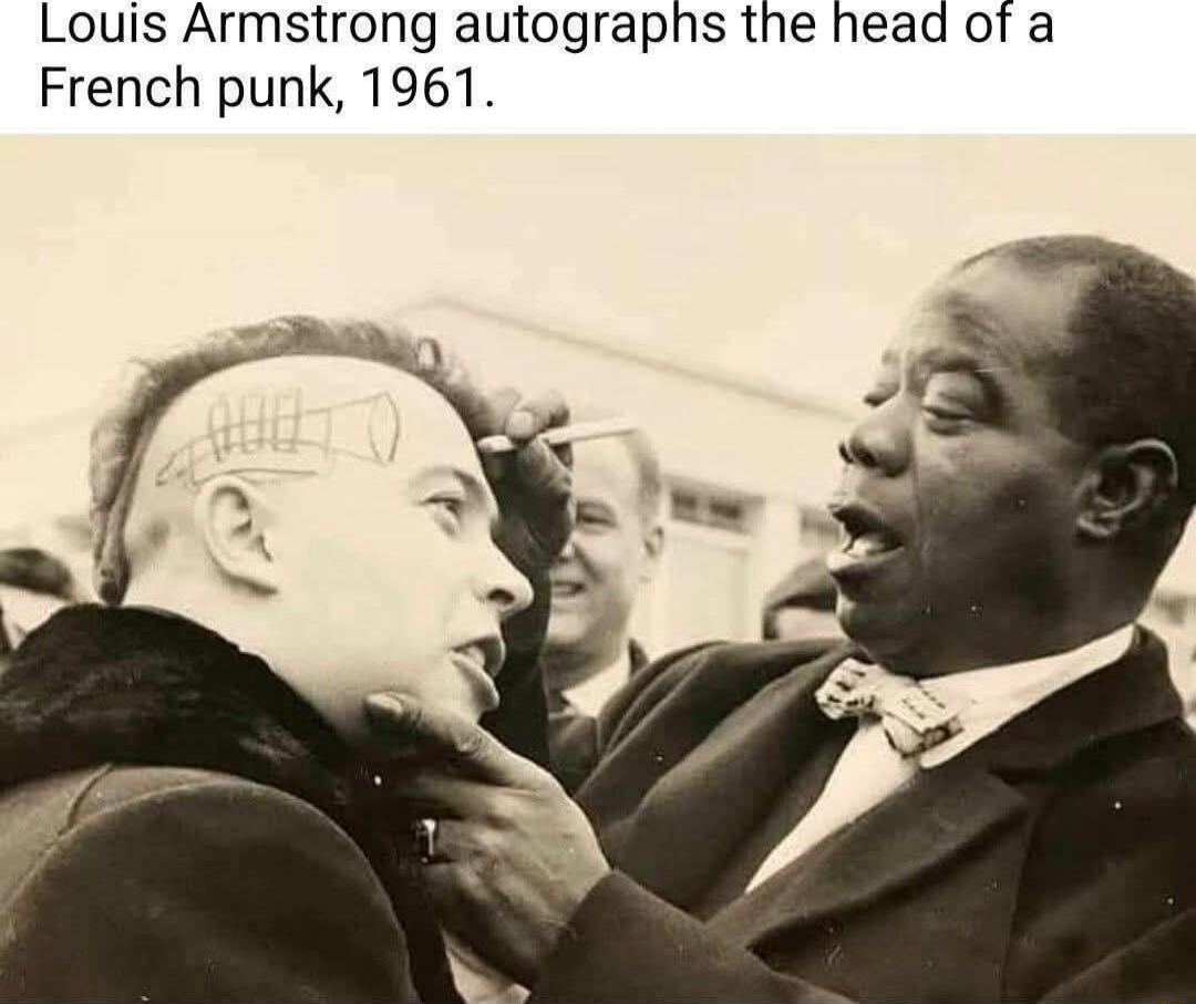 Louis Armstrong autographs the head of a French punk, 1961.