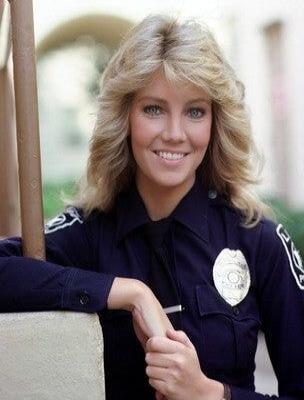 Female police officer in uniform smiling.