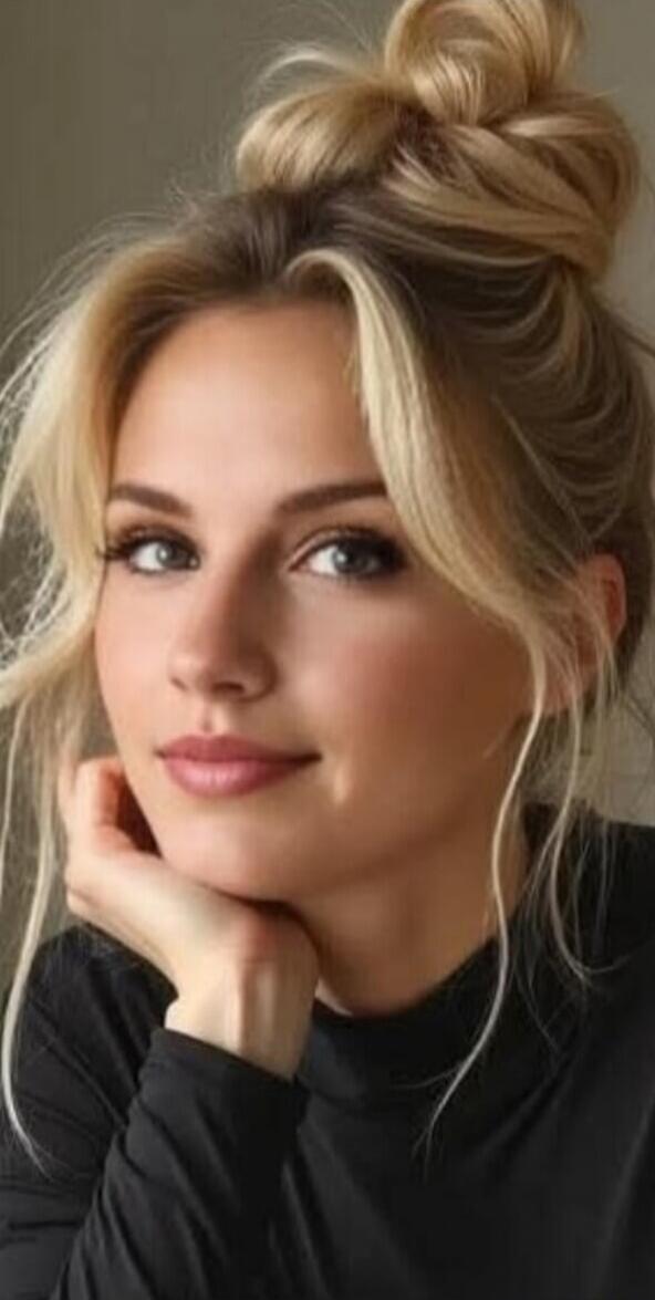 Portrait of a woman with blonde hair in a bun.