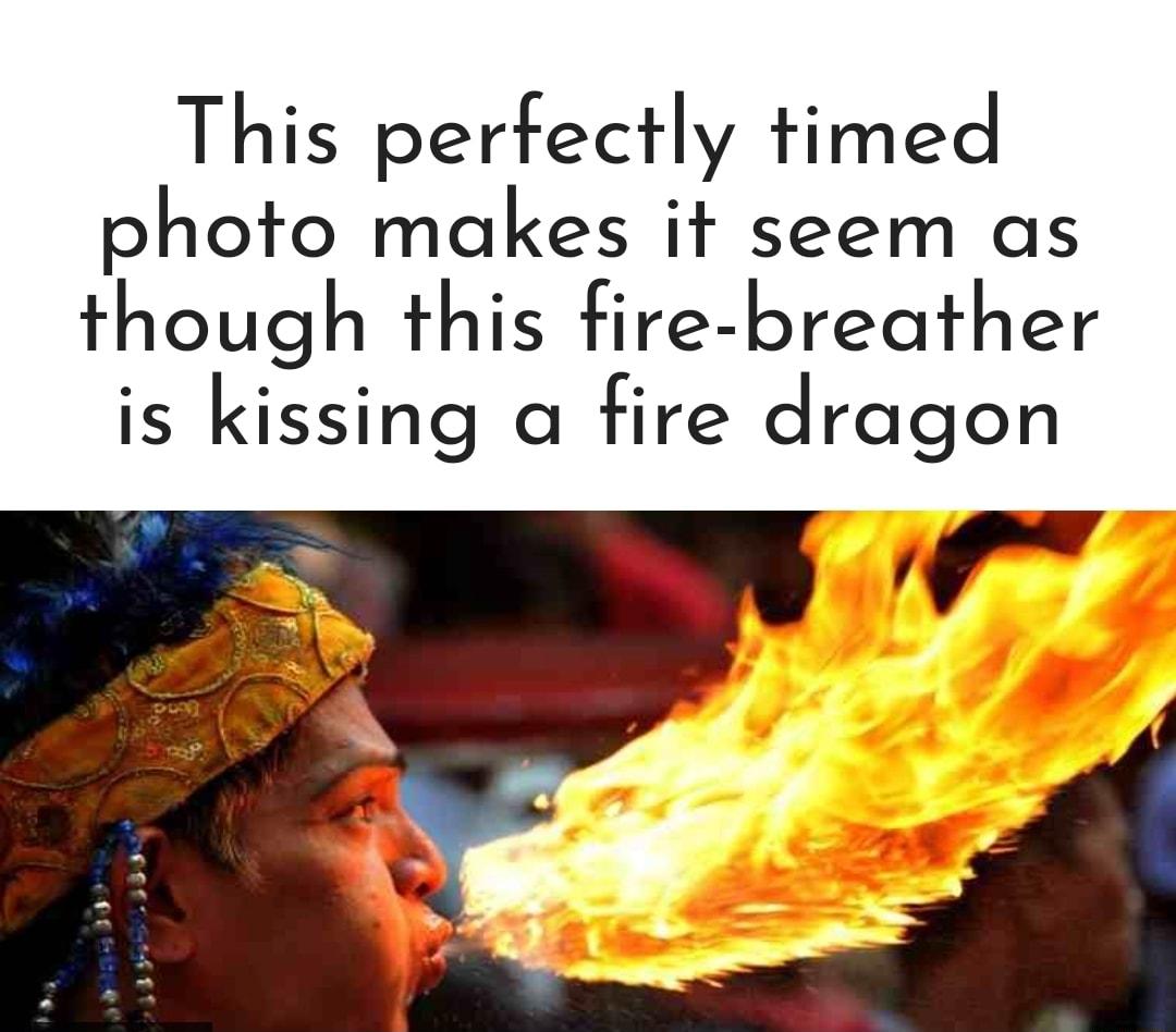 This perfectly timed photo makes it seem as though this fire breather is kissing a fire dragon