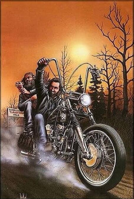 Two men riding on a motorcycle along a dirt road at sunset.