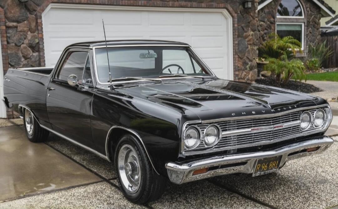 R 96 881 EL CAMINO. A classic black Chevrolet El Camino parked on a driveway in front of a house.
