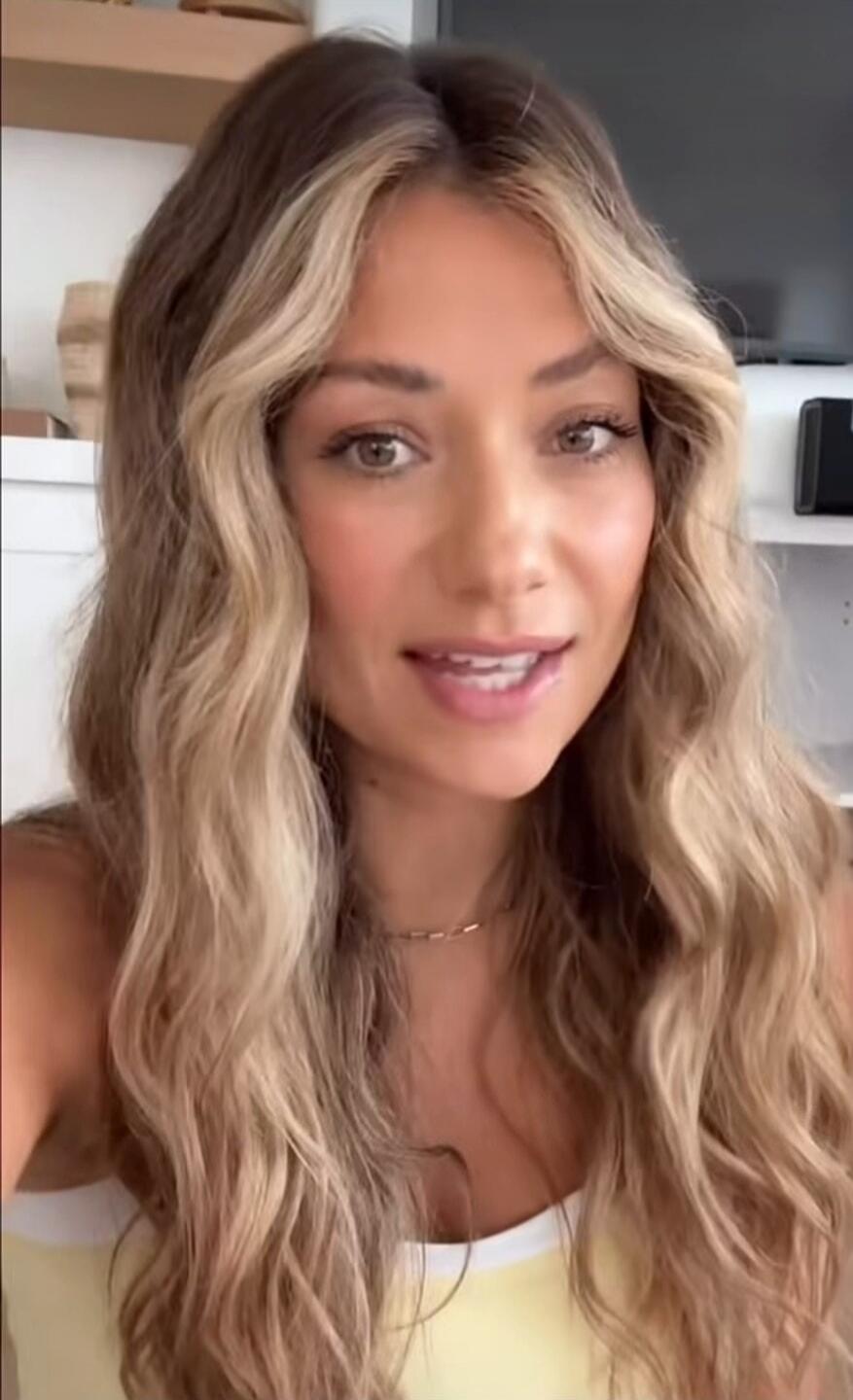 A woman is speaking directly to the camera, likely sharing thoughts or information.
