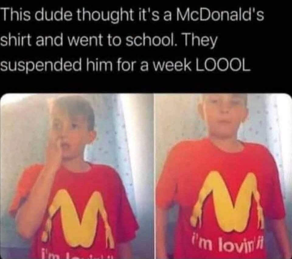 This dude thought it's a McDonald's shirt and went to school. They suspended him for a week LOOOL. The boy is wearing a red t-shirt with a yellow logo that looks like an inverted McDonald's 'M' but resembles buttocks or legs. The text on the shirt says 'i'm lovin' it'.