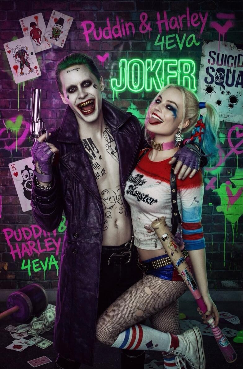 Puddin & Harley 4EVA, JOKER, SUICIDE SQUAD, HA HA HA, Damaged, Daddy's Lil Monster. The image shows Joker and Harley Quinn posing against a graffiti-covered brick wall. Joker is holding a gun, and Harley Quinn is holding a baseball bat. There are playing cards and money on the ground.
