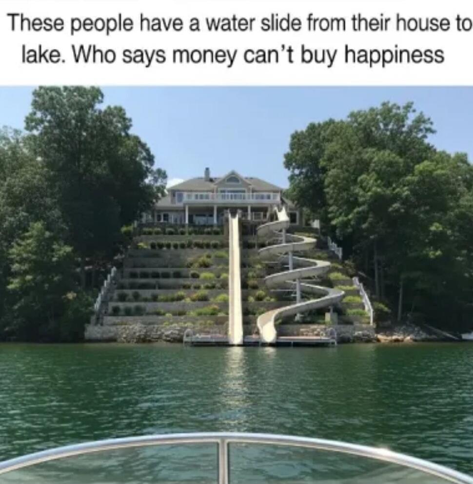 These people have a water slide from their house to lake. Who says money can't buy happiness