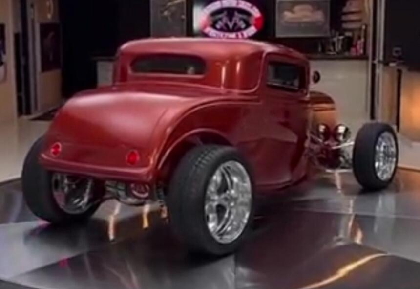Red hot rod car in a showroom.