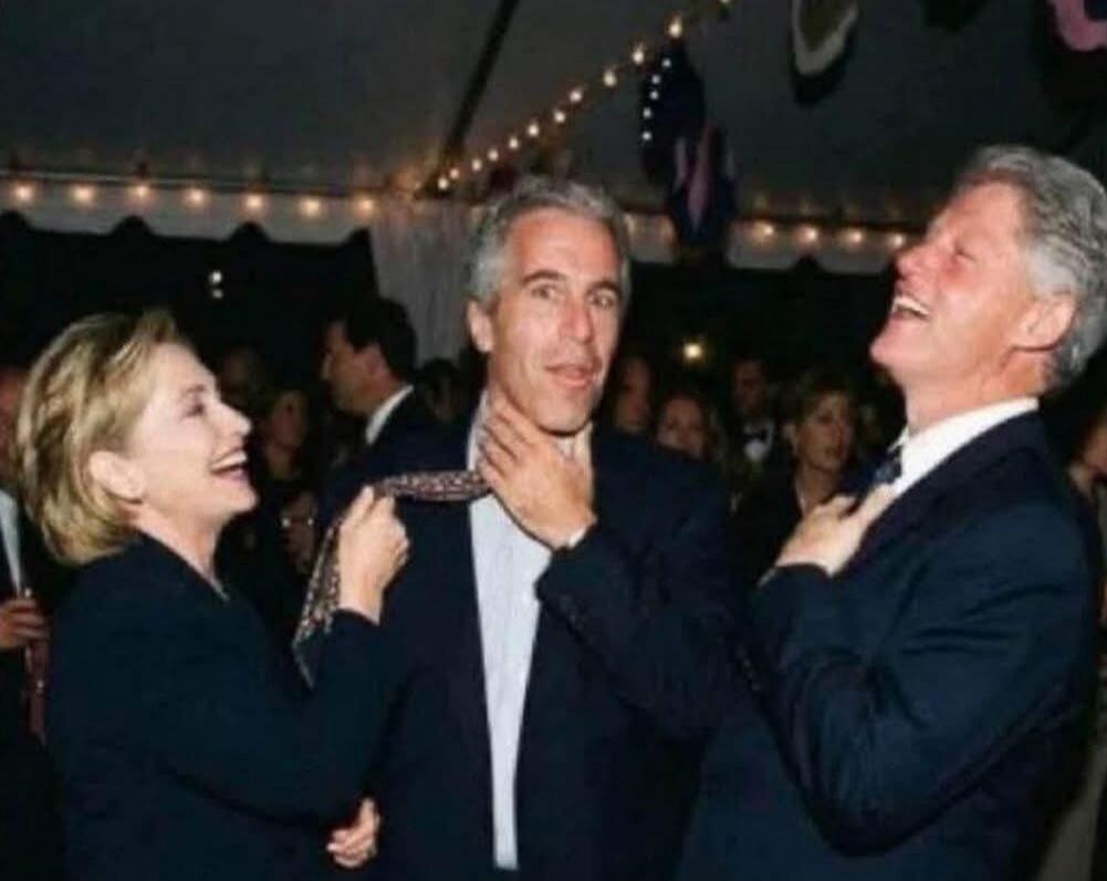 A candid photo of three adults at a formal social event.