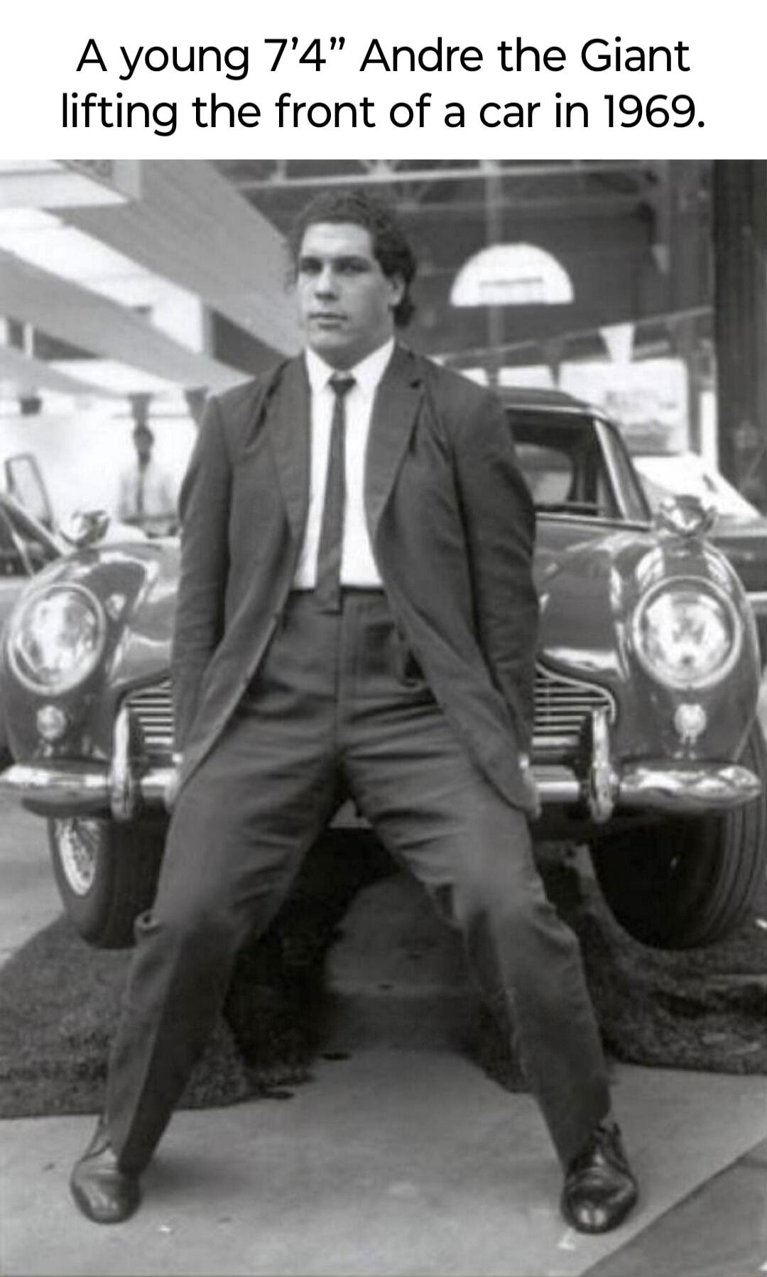 A young 74 Andre the Giant lifting the front of a car in 1969 e