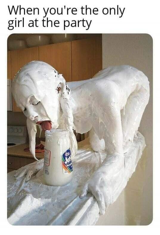 When you're the only girl at the party. A person, likely a woman, covered in a white creamy substance, possibly whipped cream or marshmallow creme, is on all fours, licking a jar of Jet-Puffed Marshmallow Creme in a kitchen setting.
