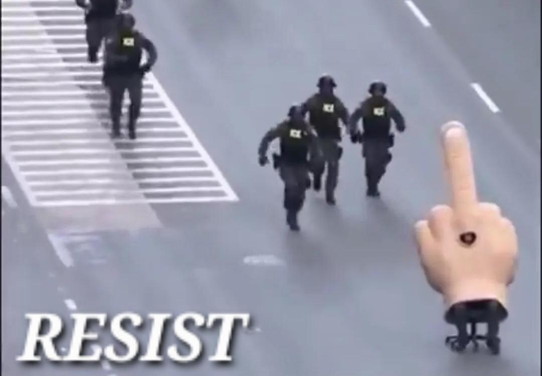RESIST. Several police or military-like figures are running on a road, while a large animated hand giving the middle finger moves along the road.