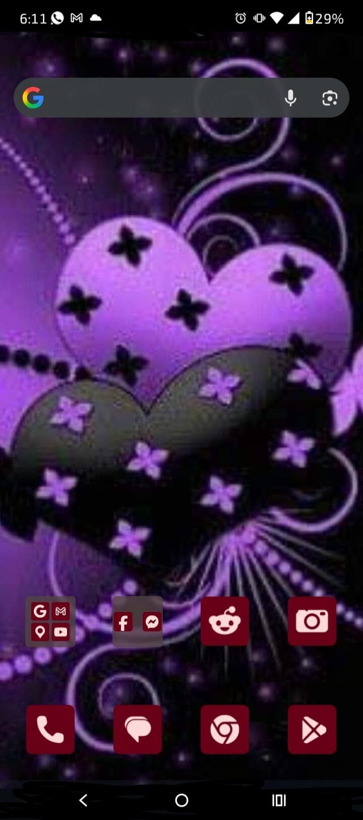 6:11 M 29% G. App icons for Google, Maps, YouTube, Facebook, Messenger, Reddit, Camera, Phone, Messages, Chrome, Play Store are visible on a dark purple wallpaper with abstract floral and heart patterns.