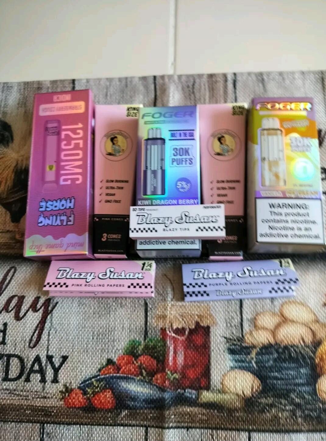 Flying Horse 1250mg Strawberry Cough Indica. Foger King Size 30K Puffs 5% Kiwi Dragon Berry. Foger King Size 30K Puffs Vanilla. Warning: This product contains nicotine. Nicotine is an addictive chemical. Blazy Susan Blazy Tips. Blazy Susan Pink Rolling Papers 3 Cones. Blazy Susan Pink Rolling Papers 1 1/4 Size. Blazy Susan Purple Rolling Papers 1 1