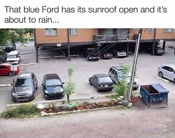 That blue Ford has its sunroof open and its about to rain