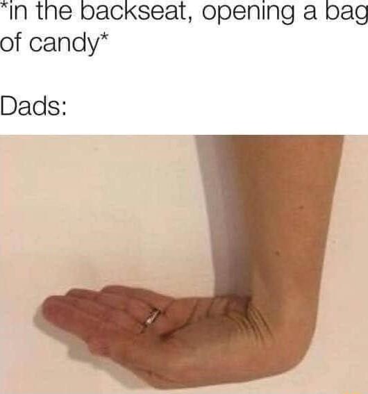 In the backseat opening a bag of candy Dads