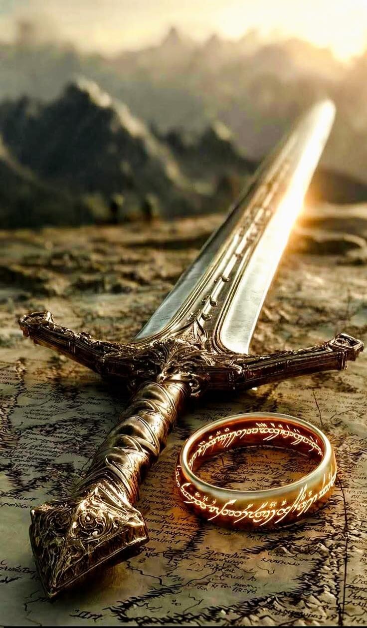 A detailed image featuring a fantasy sword and a golden ring with glowing inscription, placed on an old map. Mountains and a bright sky are visible in the background, evoking a scene from The Lord of the Rings.