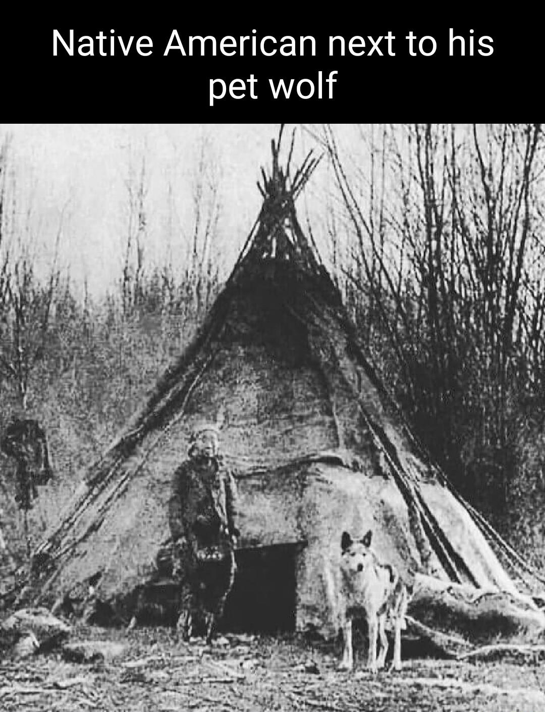 Native American next to his pet wolf