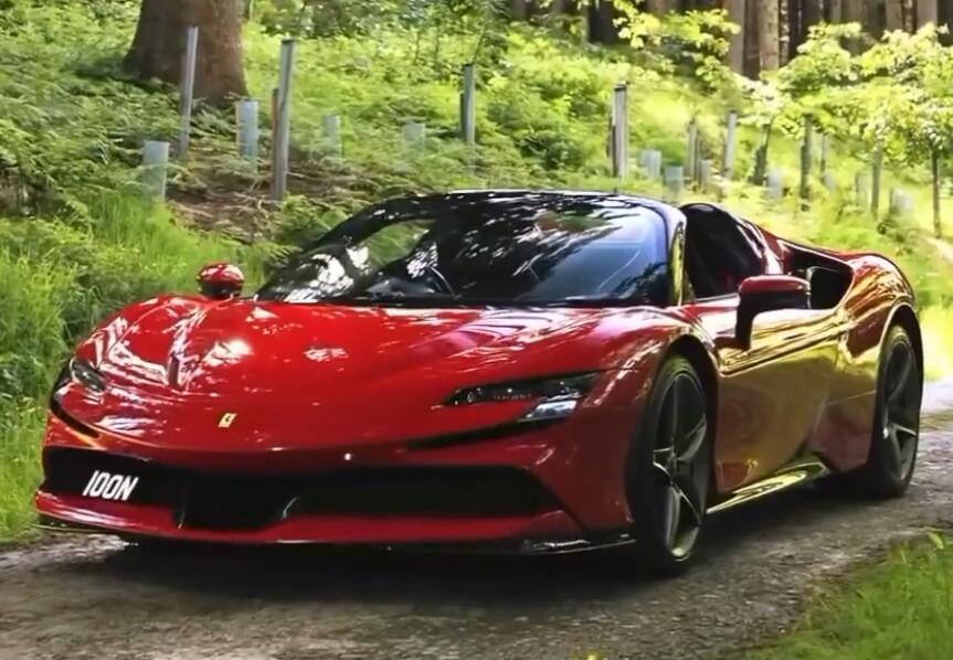 Red Ferrari sports car on a forest road.