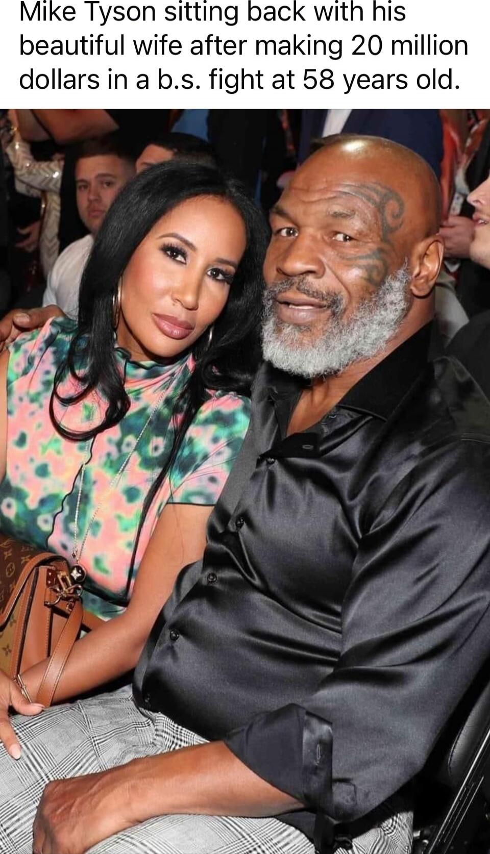 Mike Tyson sitting back with his beautiful wife after making 20 million dollars in a b.s. fight at 58 years old.