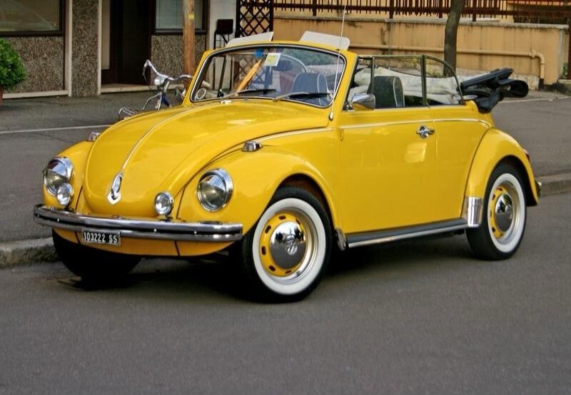 Yellow vintage convertible car (Volkswagen Beetle) on a street