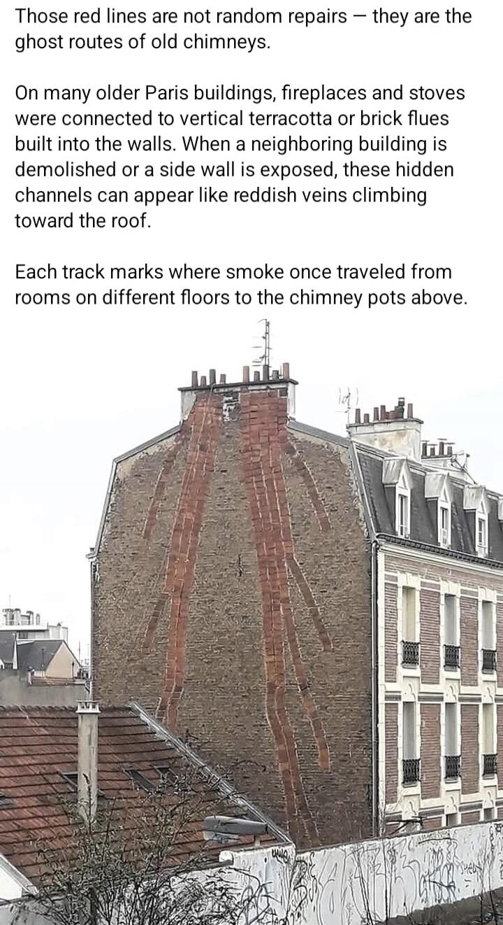 Those red lines are not random repairs - they are the ghost routes of old chimneys. On many older Paris buildings, fireplaces and stoves were connected to vertical terracotta or brick flues built into the walls. When a neighboring building is demolished or a side wall is exposed, these hidden channels can appear like reddish veins climbing toward t