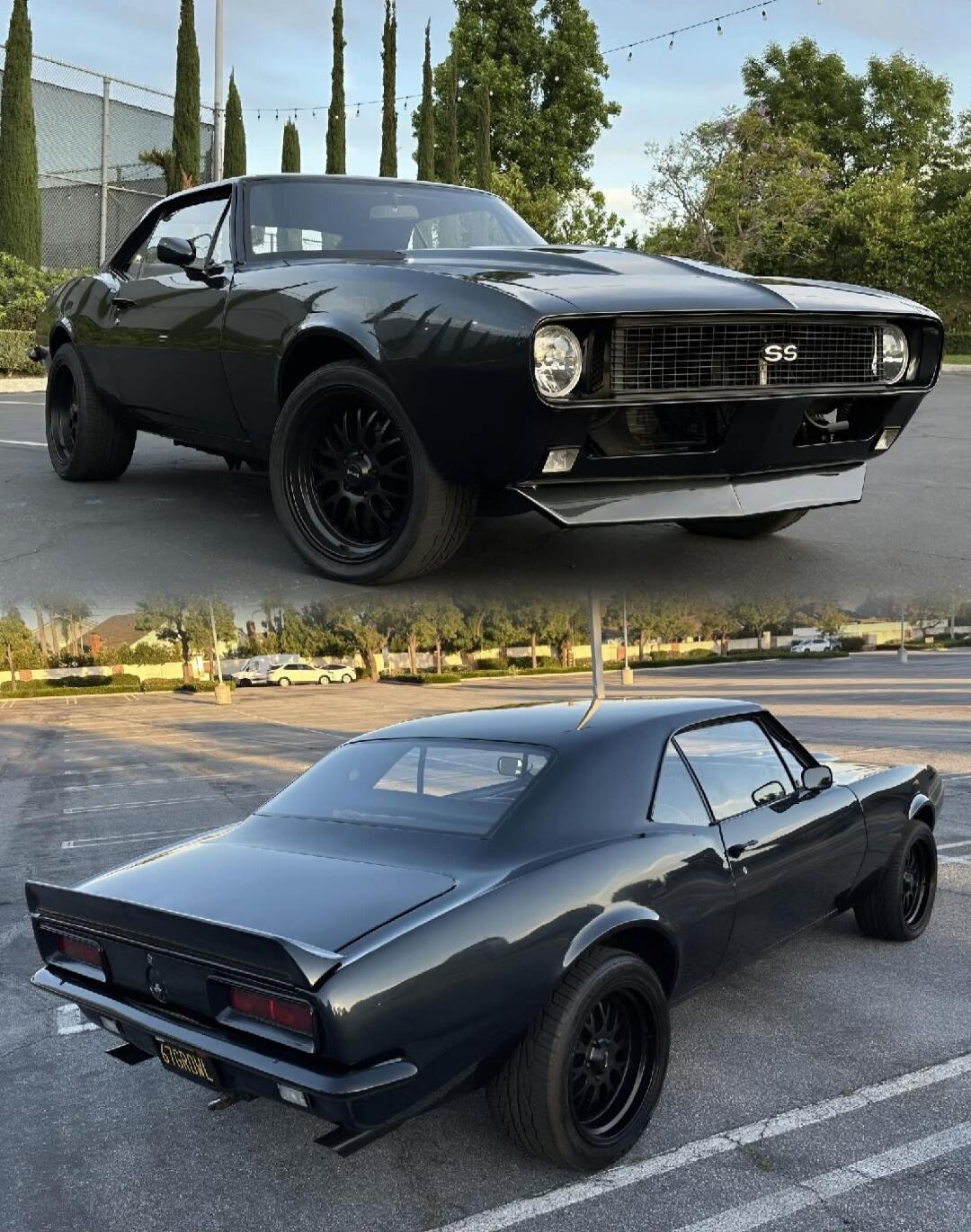 A black classic muscle car, possibly a Chevrolet Camaro, with 'SS' emblem on the grille and '67GROWL' on the license plate, parked in an outdoor lot.