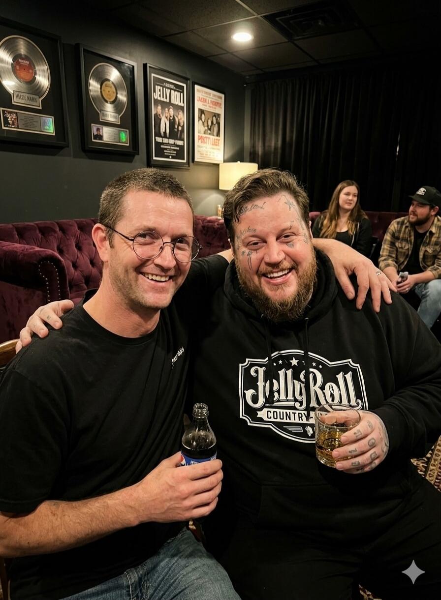 Two men smiling, one wearing a 'Jelly Roll Country' hoodie and holding a drink. Framed records and posters are visible in the background, including 'Maggie Mae', 'Jelly Roll', 'Jacob & Theophilus', and 'Pokty Lady'.