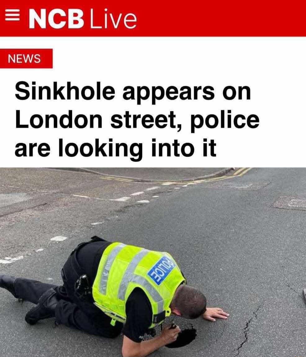 NCB Live NEWS Sinkhole appears on London street, police are looking into it. A police officer is kneeling on the road, literally looking into a small crack in the asphalt.