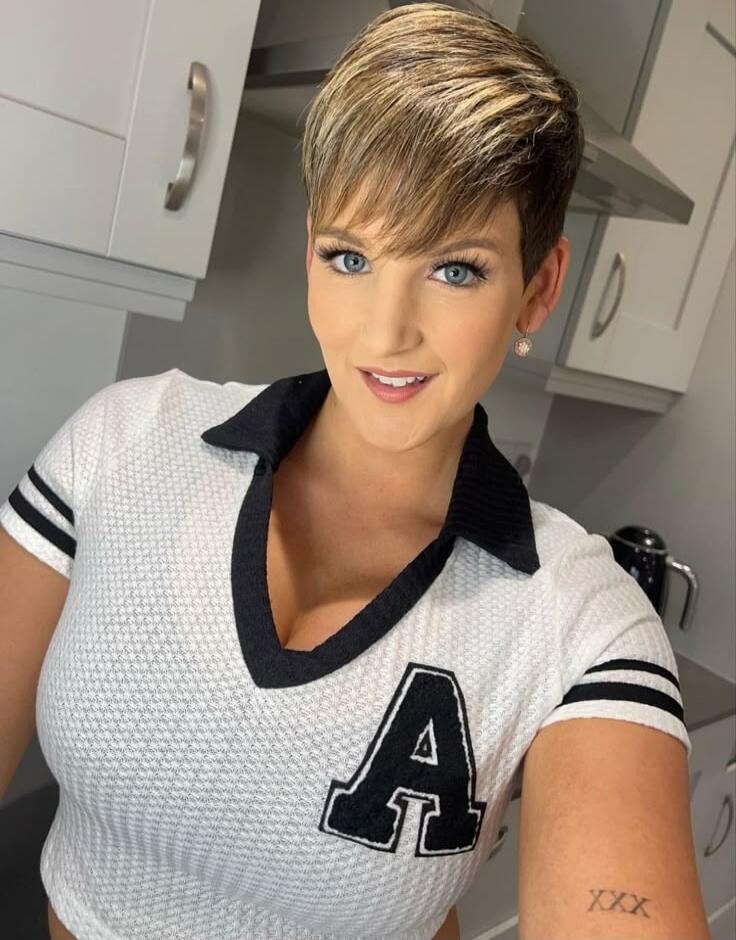 A emblem on shirt; XXX tattoo on forearm